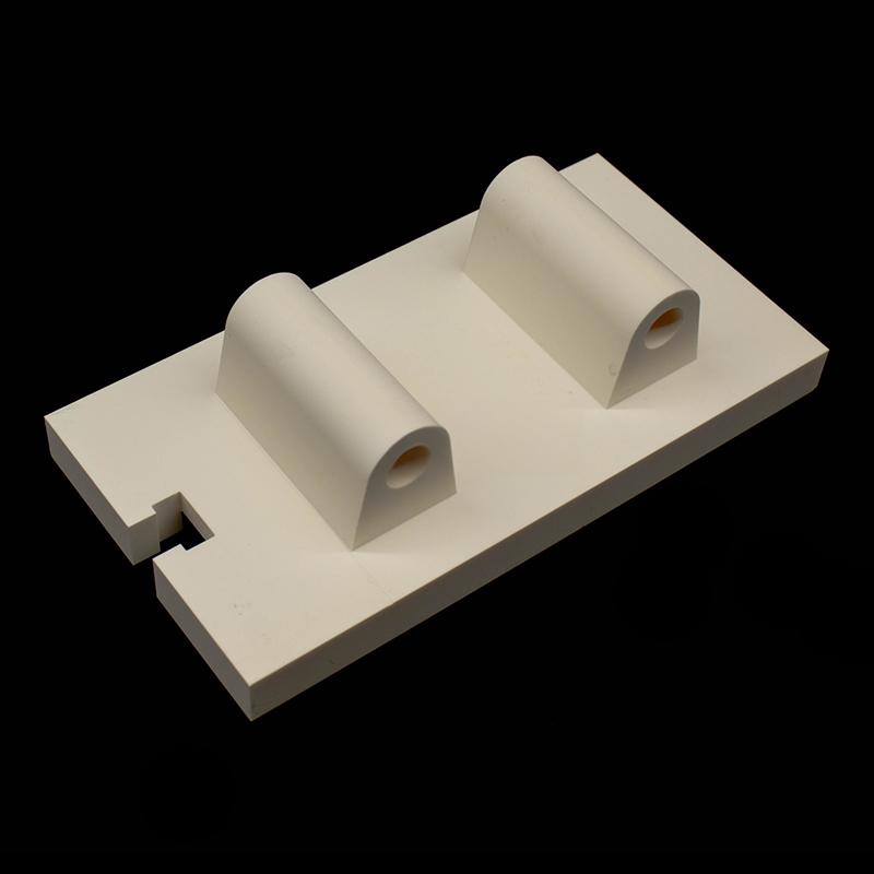 Aluminum oxide ceramic shaped part with a central protrusion and hole