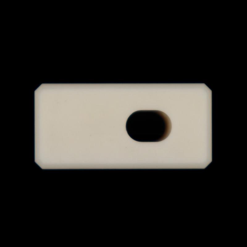 Aluminum oxide ceramic structural component with circular grooves and threaded holes inside the rectangular body