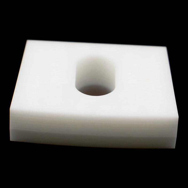 Elliptical through-hole square ceramic structural component
